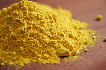 yellow powder on wooden background