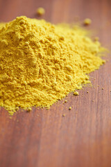 yellow powder on wooden background