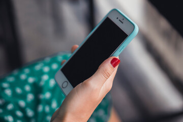 young woman using smartphone in hand on the street