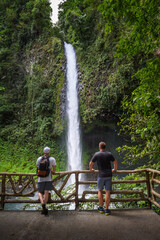 Two tourists looking at the La Fortuna Waterfall in Costa Rica