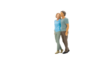 Fototapeta premium Miniature people couple in casual cloth standing together isolated on white background with clipping path.