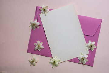 Minimalistic card mockup with white flowers, flower, craft envelope, blossom, flat lay, top view