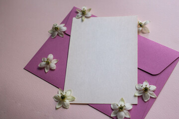 Minimalistic card mockup with white flowers, flower, craft envelope, blossom, flat lay, top view