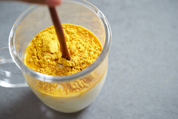 Milk and powder mix in a glass cup