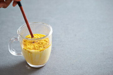 Milk and powder mix in a glass cup