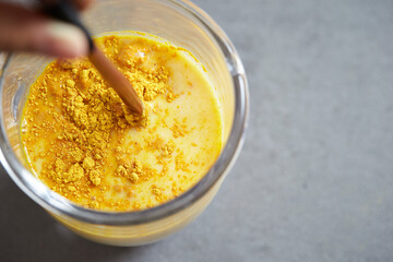 Milk and powder mix in a glass cup