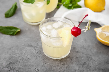 Glasses of delicious mai tai cocktail on grey background