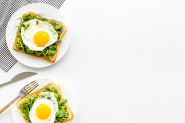 Sandwich with eggs avocado cream and spinach, top view