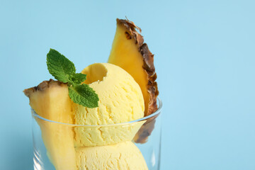 Glass with tasty pineapple ice cream on color background, closeup