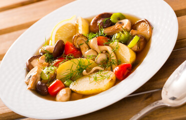 Lenten pottage in country style of mushrooms with vegetables, lemon and fresh greens..