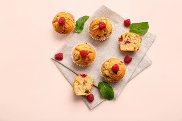 Tasty raspberry muffins on color background