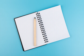 Blank paper and pencil on a blue background