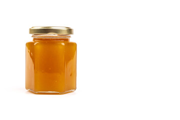 Glass jar full of sweet honey isolated on white background