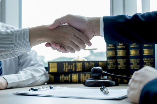 Handshake After Lawyer  Providing Legal Consult Business Dispute Service To The Man At The Office With Justice Scale And Gavel Hammer