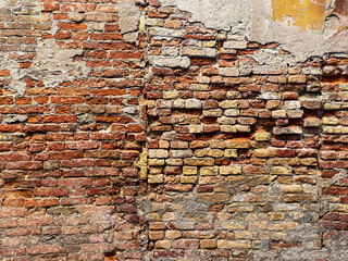 Horizontal part of a Venetian old red brick wall, background,
