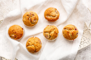 Tray with tasty raspberry muffins on light background