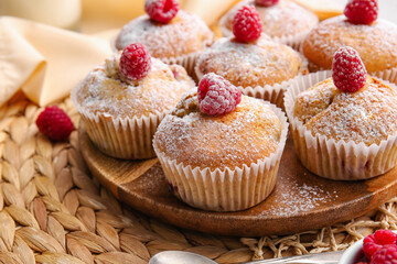 Plate with tasty raspberry muffins on table, closeup