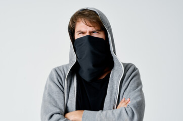 a man in Balaklava with a hood anonymity theft neatness to crime