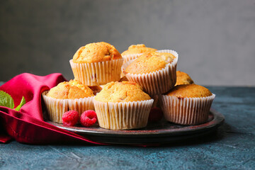 Plate with tasty raspberry muffins on table, closeup