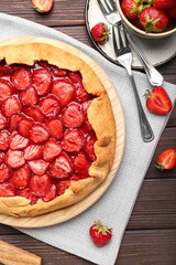 Composition with tasty strawberry pie on dark wooden background