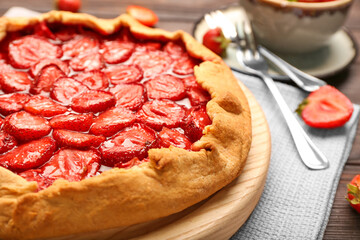 Board with tasty strawberry pie on table, closeup