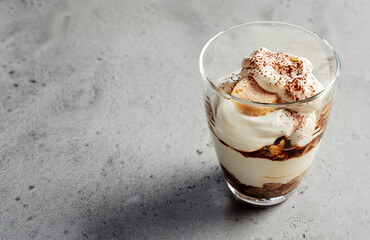 Tiramisu dessert in glass on table