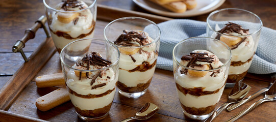 Traditional Tiramisu in glasses on tray