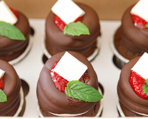 Chocolate cupcakes with jam and mint close-up