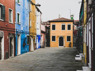 Naklejka na ściany i meble Colorful houses on a small traditional square at Burano island, Venice, Italy
