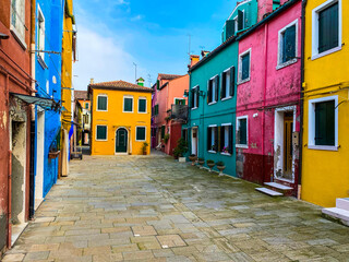 Colorful houses on a small traditional square at Burano island, Venice, Italy