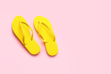 Stylish flip-flops on color background