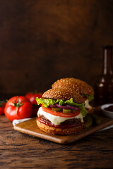 Traditional homemade cheeseburgers with pickles