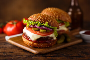 Traditional homemade cheeseburgers with pickles