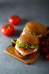 Traditional homemade cheeseburgers with pickles