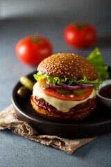 Traditional homemade cheeseburgers with pickles