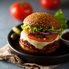 Traditional homemade cheeseburgers with pickles