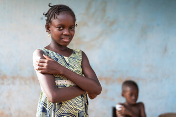 Relieved beautiful little black girl pressing her fingers firmly on the injection site covered by a...