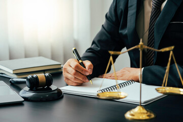 justice and law concept. the judge in a courtroom with the gavel, male judge with writing documents...