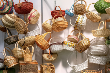 Empty wicker baskets in stock. Collection of various wicker baskets at the fair.