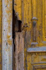 Old yellow wooden gate without a handle.