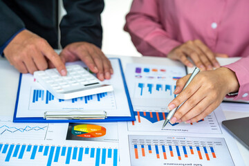 Marketers and financial accountants are discussing and analyzing charts to plan strategies to meet customer needs, Brainstorm teams, Team meetings, or business