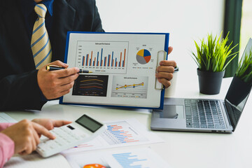 Marketers and conference leaders on business plans and marketing strategies using laptops for data analysis Using business data graphs in meetings. Business brainstorming,