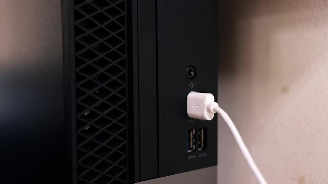 closeup clip of a desktop usb port with usb cable