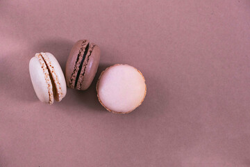 macarons on a paper background, brown and beige background