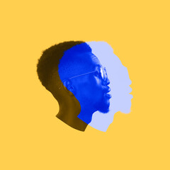 Close-up young African man's face, head with colored silhouette, shadow isolated on light background. Facial expression, human emotion concept.