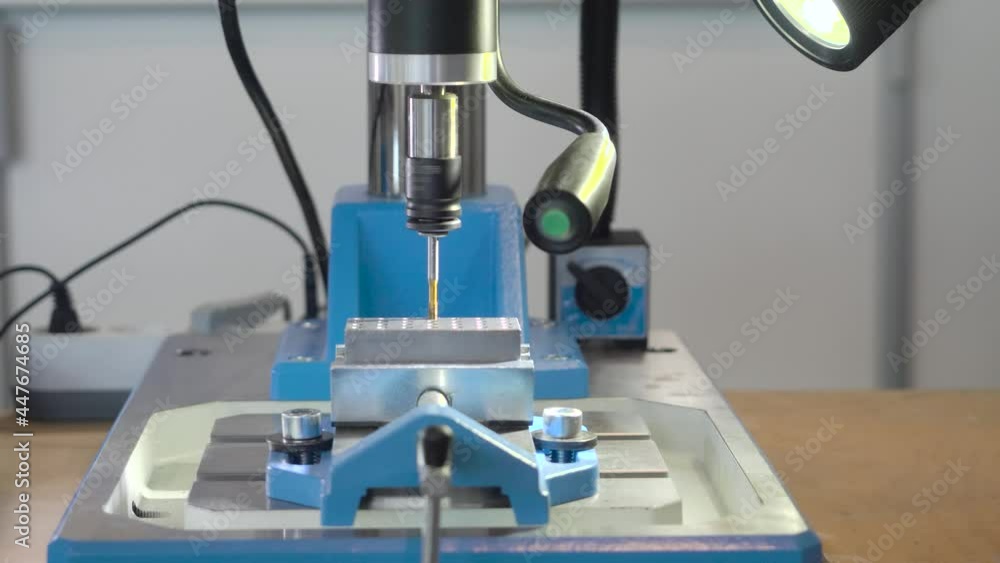 Poster modern small machine with drill. hdr. desktop machine with light for spot drilling with high precisi