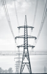 Long lines of power line towers stretching across a Winter Landscape.