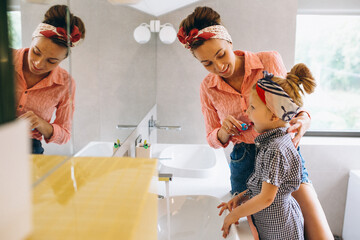 Mother and daughter making masks home