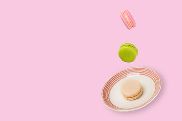 Obraz na płótnie Canvas Colorful macaroons floating on a ceramic plate. Food levitation concepts.