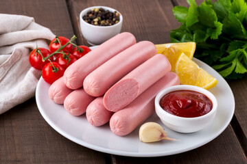 Raw sausages on wooden board